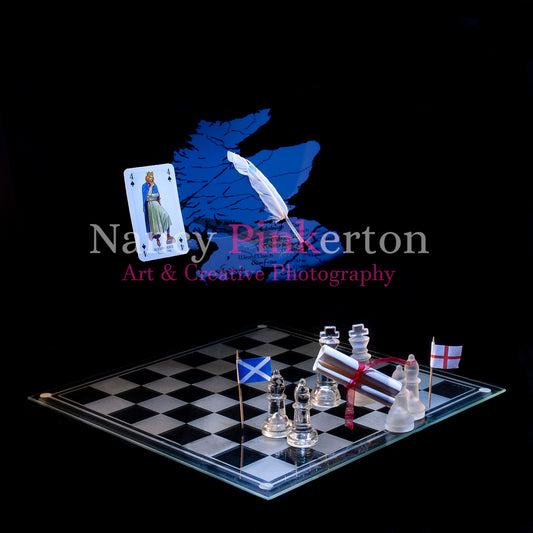 Photographic art print with image of a playing card featuring King Alexander the II, a graphic of map of Scotland and a quill floating above a chessboard with the flags of Scotland and England either side of two king pieces holding a scroll.