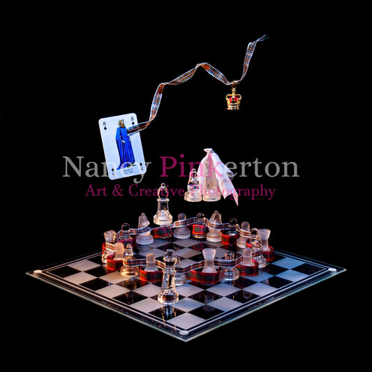 Photographic art print with image of a playing card featuring King Robert II with the Royal Stewart tartan connecting to a crown floating above a glass chessboard chess pieces arranged in a circle interwoven with the Bruce and Royal Stewart tartans